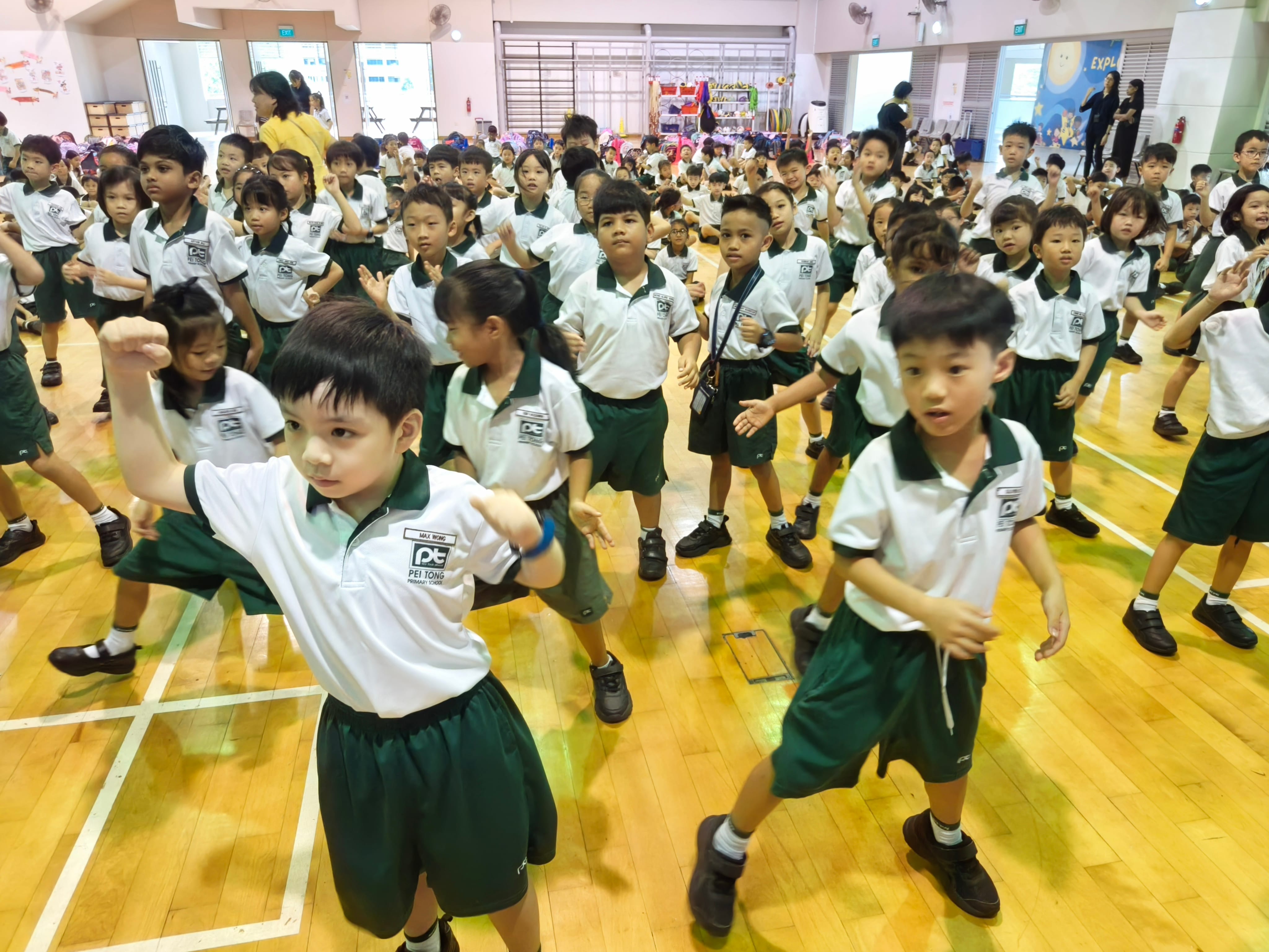 Students participate enthusiastically in a mass dance session, following coordinated movements together while building teamwork, confidence and school spirit.